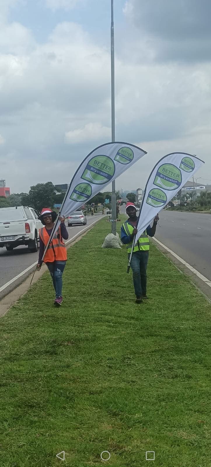 Volunteers with Better Bryanston flags